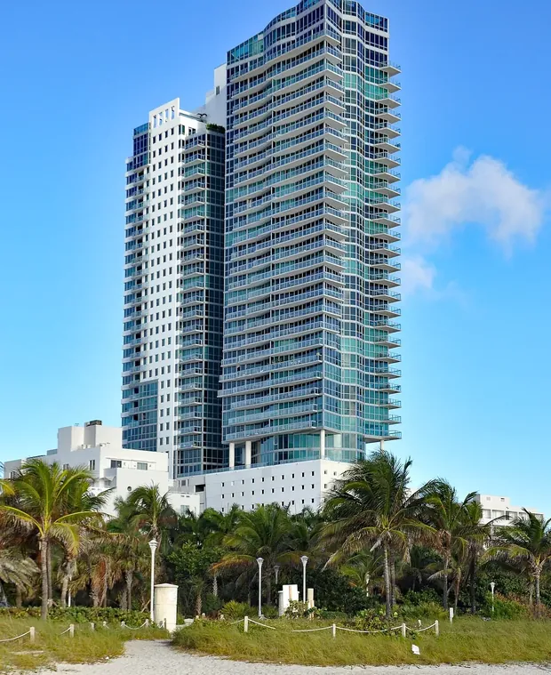 Oceanfront residential tower and palms in Miami Beach